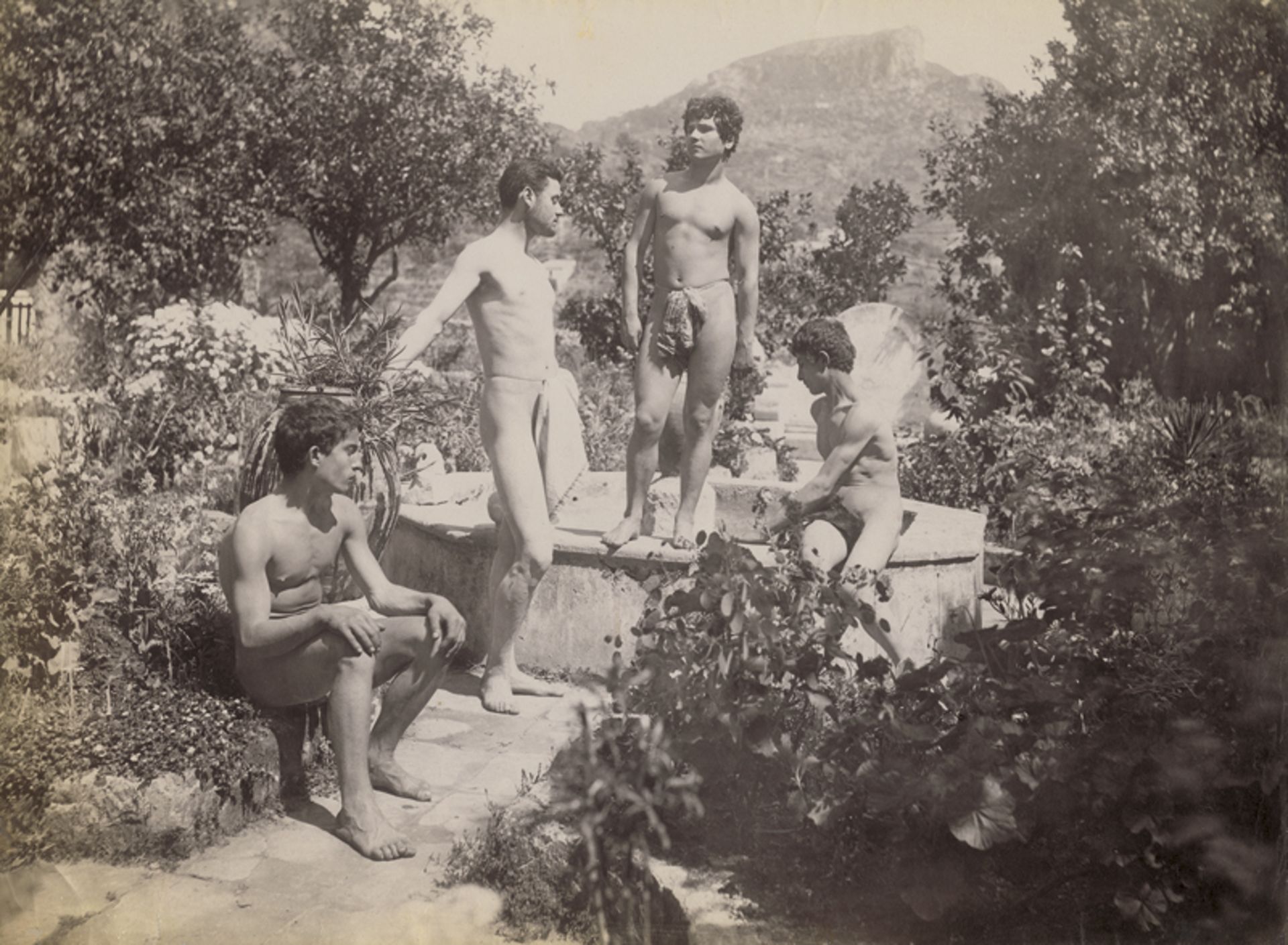 Gloeden, Wilhelm von: Young male nudes by fountain