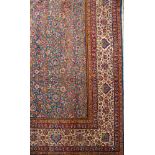 A Kerman carpet of large size:, the indigo field with an all over geometric design of palmettes,