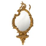 WITHDRAWN A 19th Century carved gilt gesso mirror of cartouche outline:, the plate with rocaille,