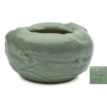 A Chinese celadon brush washer: of circular form moulded with two carp swimming amongst waves,