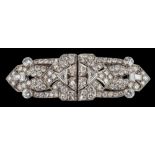 An Art Deco diamond encrusted double clip brooch: mille-grain-set with round,