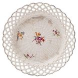A Chelsea basket pattern dish: painted with four floral sprays,