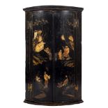 An 18th Century black lacquer and chinoiserie bow fronted hanging corner cupboard:,