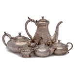 An Indian silver five piece tea & coffee service: the coffee and teapot with ceramic insulators to