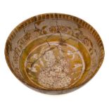 A Kashan lustre bowl: of rounded form with flared footrim,