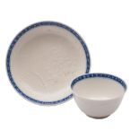 A Chinese blue and white soft-paste teabowl and saucer: thinly potted and decorated in white relief