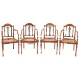 A set of four Sheraton period satinwood and decorated elbow chairs:, painted with floral foliage,