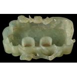 A Chinese carved nephrite brush washer: of scroll form, the rim carved with a chilong and lingzhi,