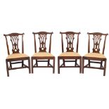 A set of four George III carved mahogany dining chairs in the Chippendale taste:,
