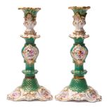 A pair of early 19th century English porcelain baluster candlesticks: each moulded with acanthus