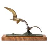 An Art Deco bronze group of seagulls: modelled flying above crested waves,