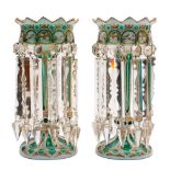 A pair of Bohemian green and white overlay glass lustres: of conventional form hung with prismatic