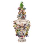 A Bow frill vase and cover: of traditional pierced form with bird finial, applied with female masks,