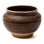 A small Chinese brown-glazed stoneware bowl: of rounded form, the foot unglazed, Song dynasty,