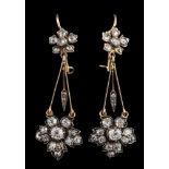 A pair of diamond mounted floral motif drop earrings: each with a rose diamond-set cluster