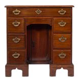 A mid 18th Century mahogany kneehole desk:, of small size, the top with a moulded edge,