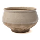 A Chinese Cizhou stoneware bowl: with rolled rim, rounded sides and short cylindrical footrim,