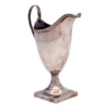 A George III silver cream jug, maker's mark worn, London, 1809: of helmet-shaped outline,