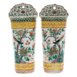 A pair of Chinese famille verte wall pockets: each with ruyi-shaped back and enamelled with a bird