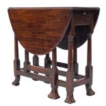 An early 18th Century walnut gateleg table:, of small size, with an oval hinged top,