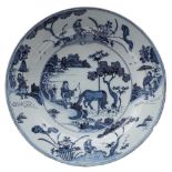 A Frankfurt faience charger: painted in trekked inky blue in the Chinese Transitional style with a