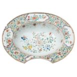 A Chinese famille rose barber's bowl: the centre painted with peaches and flowering plants,
