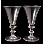 A pair of English wine glasses: each with trumpet shaped bowl and basal collar,
