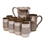 An Indian silver nine-piece cordial set: with banded embossed foliate decoration includes jug and