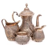 An Indo- Persian three- piece silver tea service: of baluster form with engraved foliate decoration,