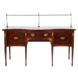 A 19th Century mahogany and inlaid serpentine fronted sideboard:, bordered with boxwood lines,