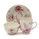 A First Period Worcester trio: painted in puce camaieu with floral sprays,