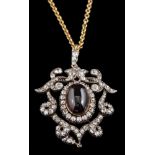 A 19th century carbuncle garnet and diamond open work pendant/brooch: the central,