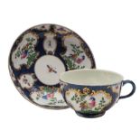 A First Period Worcester blue scale coffee cup and saucer: painted with gilt rococo cartouches of