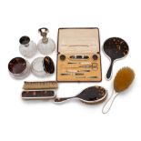 An Art Deco period tortoiseshell and silver mounted matched dressing table set,