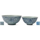 A Chinese blue and white peony scroll bowl and a similar smaller example: each with rounded sides