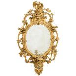 A 19th Century carved giltwood and gesso oval girandole mirror:,