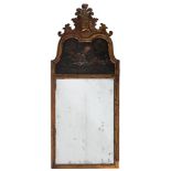 A carved walnut, partly gilt and decorated wall mirror in the early 18th Century taste:,