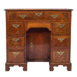 An early 18th Century walnut and cross and feather banded secretaire kneehole desk:,