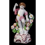 A Plymouth figure of a putto: with bocage support and holding a flower aloft,