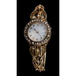 A lady's 19th century hinged bangle watch: the circular guilloche dial with Arabic numerals,