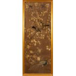 A pair of large Chinese silkwork panels: depicting birds amongst flowering shrubs, worked in creams,