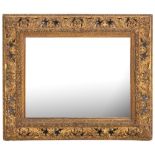 A late 19th Century moulded gilt gesso rectangular mirror:, the plate within a foliate slip,