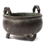 A Chinese bronze censer: of circular outline with simulated bamboo loop carrying handle with three