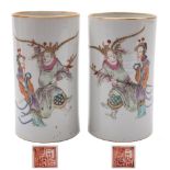 A pair of Chinese famille rose cylindrical vases: each painted with two figures from a scene from