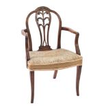 A George III carved mahogany elbow chair:, in the Hepplewhite taste,