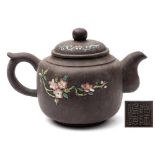 A Chinese Yixing teapot and cover: enamelled with peaches and blossom, potter's seal mark,