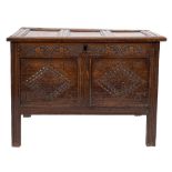 A late 17th Century carved oak rectangular coffer:, with a plain triple moulded panel hinged top,