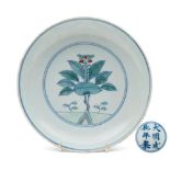 A Chinese doucai saucer dish: the interior painted with a medallion enclosing a pomegranate tree