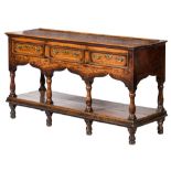 An early 18th Century oak rectangular dresser base:, of small size with a ledge back,