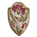 An early 18th Century needlework purse: of shield-shaped form,